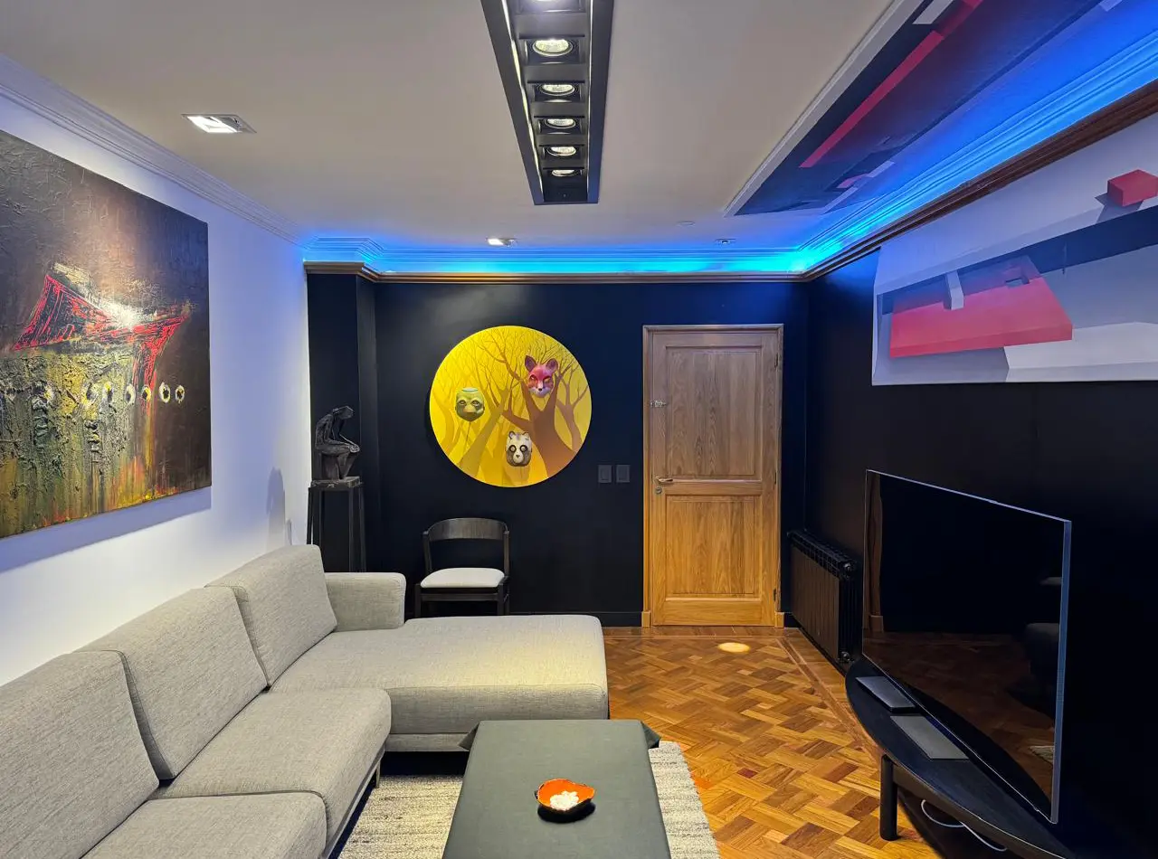 Contemporary refurbished apartment showcasing refined architectural details, premium furniture, a striking black feature wall, and an art-filled interior with layered styling.