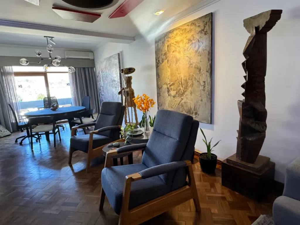 Contemporary refurbished apartment showcasing refined architectural details, premium furniture, a striking black feature wall, and an art-filled interior with layered styling.