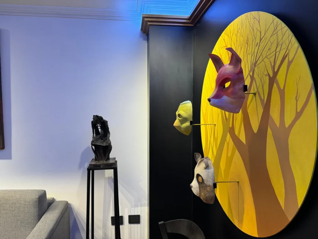 Contemporary refurbished apartment showcasing refined architectural details, premium furniture, a striking black feature wall, and an art-filled interior with layered styling.